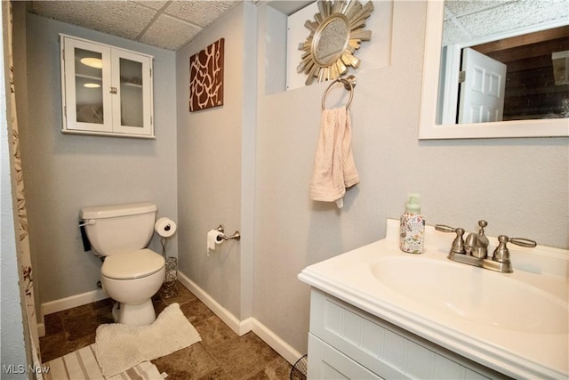 6892 Glenwood Ave, Youngstown, OH 44512 - bathroom with toilet, vanity, baseboards, and a drop ceiling