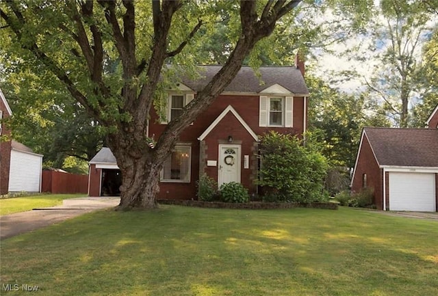 6892 Glenwood Ave, Youngstown, OH 44512 - traditional-style house featuring a garage, a front yard, and a chimney