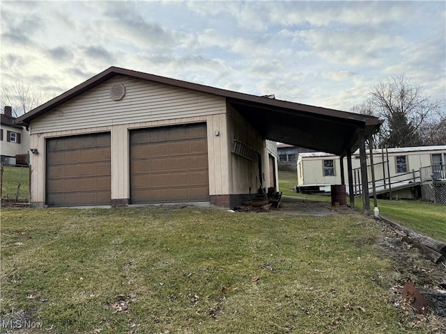 106 High St, Bloomingdale, OH 43910 - view of home's exterior featuring an outdoor structure, a detached garage, and a yard