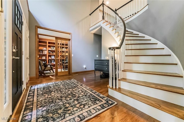 8698 Chase Dr, Chagrin Falls, OH 44023 - foyer entrance featuring a high ceiling, wood finished floors, stairway, and baseboards