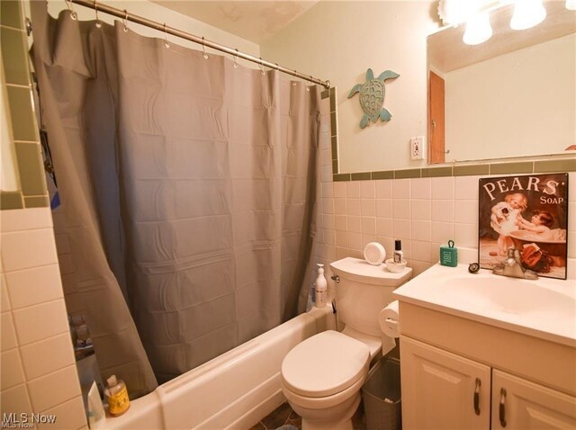 3000AND2996 Kemble Ave, Coventry, OH 44319 - full bathroom with shower / bathtub combination with curtain, vanity, tile walls, toilet, and wainscoting