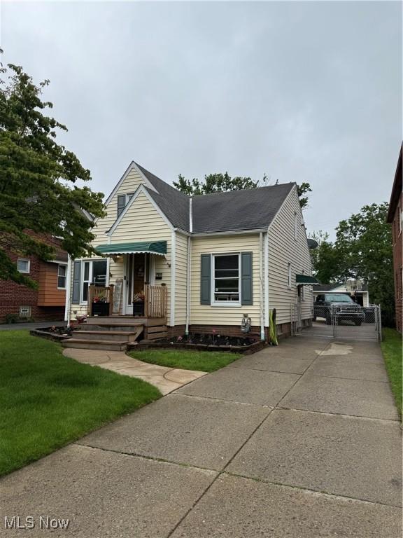 7511 Jameson Rd, Parma, OH 44129 - bungalow-style house with driveway, a front lawn, and roof with shingles