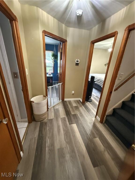7511 Jameson Rd, Parma, OH 44129 - corridor with wood finished floors, baseboards, and stairs