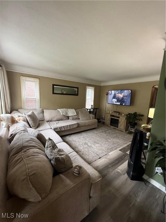 7511 Jameson Rd, Parma, OH 44129 - living room featuring wood finished floors and crown molding