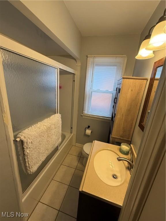7511 Jameson Rd, Parma, OH 44129 - full bath with tile patterned floors, vanity, toilet, and enclosed tub / shower combo