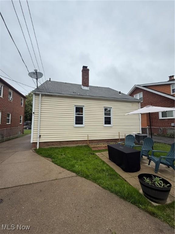 7511 Jameson Rd, Parma, OH 44129 - back of property with a chimney, central AC, and a patio area