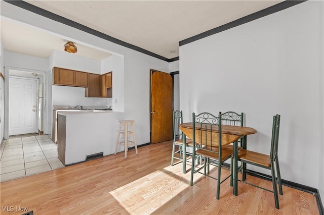932 Cole Ave, Akron, OH 44306 - dining area with light wood finished floors and crown molding