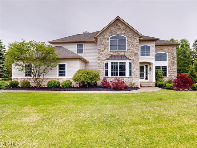 8836 Shetland Ct, Kirtland, OH 44094 - view of front of home featuring stone siding and a front lawn