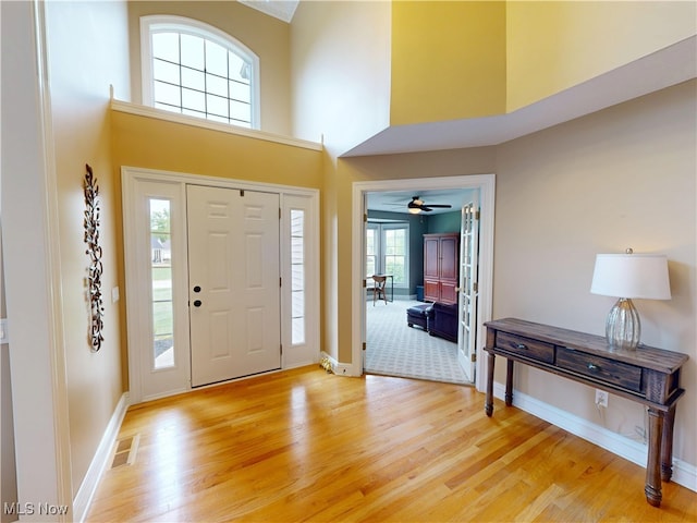 8836 Shetland Ct, Kirtland, OH 44094 - entrance foyer with a towering ceiling, light wood-type flooring, and baseboards