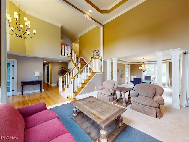 8836 Shetland Ct, Kirtland, OH 44094 - living room with a chandelier, ornamental molding, ornate columns, a high ceiling, and stairs