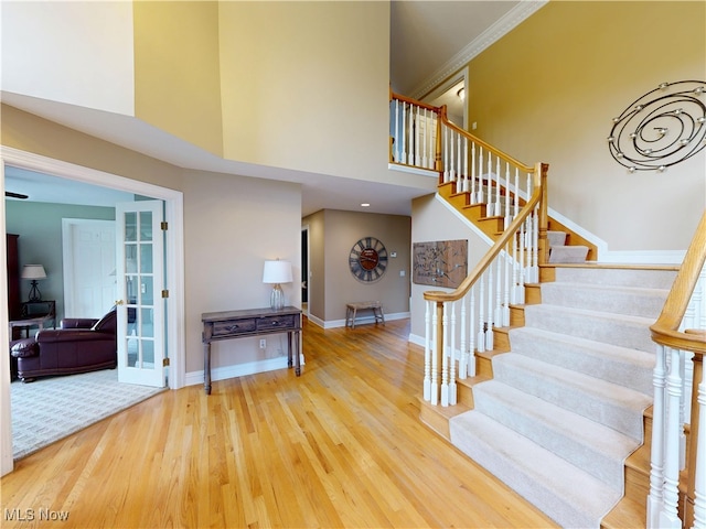 8836 Shetland Ct, Kirtland, OH 44094 - stairway with wood finished floors, a high ceiling, and baseboards
