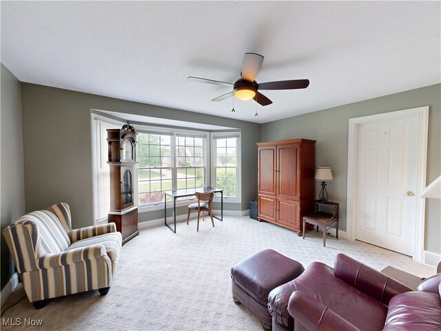8836 Shetland Ct, Kirtland, OH 44094 - living room featuring light carpet, baseboards, and ceiling fan