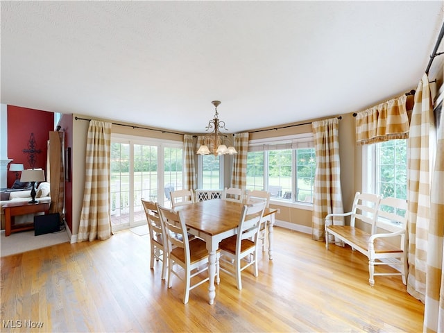 8836 Shetland Ct, Kirtland, OH 44094 - dining space with a chandelier, light wood-style flooring, and baseboards