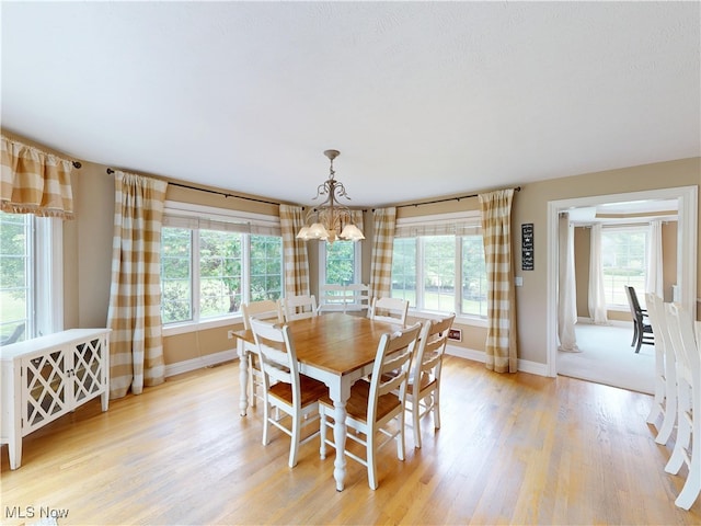 8836 Shetland Ct, Kirtland, OH 44094 - dining space with a chandelier, plenty of natural light, and baseboards