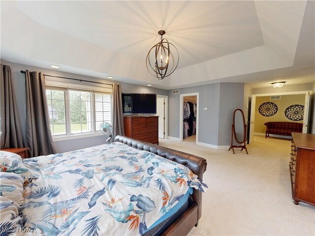 8836 Shetland Ct, Kirtland, OH 44094 - bedroom featuring light colored carpet, a chandelier, a raised ceiling, a spacious closet, and baseboards