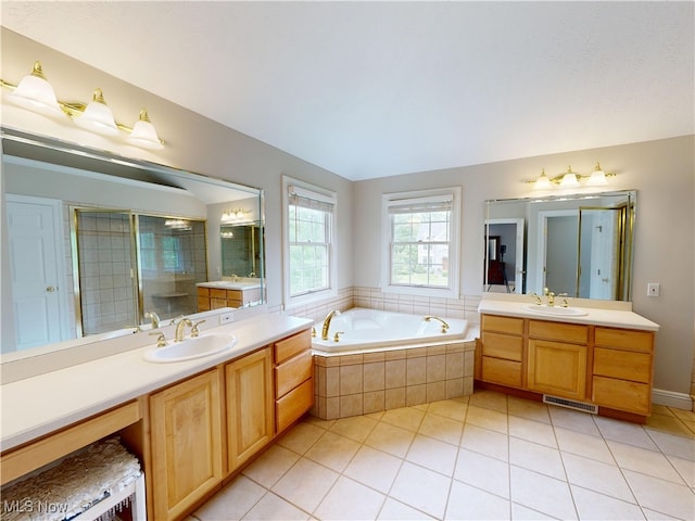 8836 Shetland Ct, Kirtland, OH 44094 - full bathroom with two vanities, a garden tub, tile patterned floors, and a tile shower