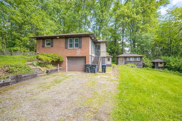 745 W Thornton St, Akron, OH 44307 - view of front of house featuring driveway, brick siding, and an attached garage
