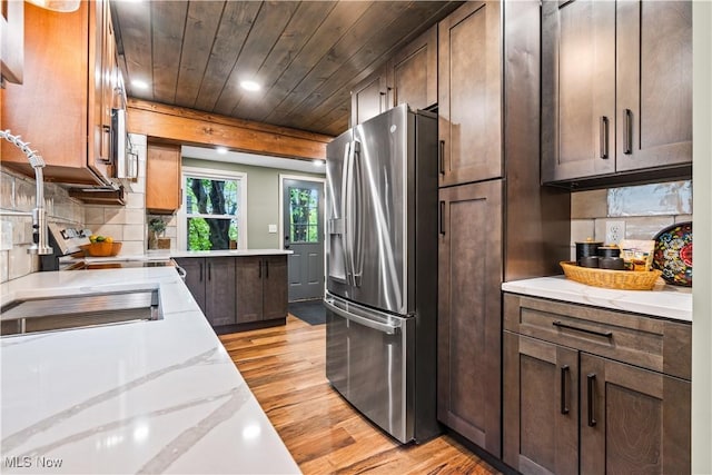 4493 Golfway Rd, South Euclid, OH 44121 - kitchen with stainless steel fridge, light wood-type flooring, recessed lighting, light stone counters, and backsplash