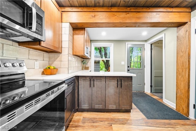 4493 Golfway Rd, South Euclid, OH 44121 - kitchen with appliances with stainless steel finishes, a peninsula, light countertops, decorative backsplash, and wood ceiling