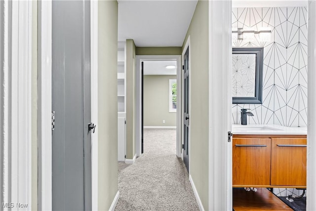 4493 Golfway Rd, South Euclid, OH 44121 - hall with a sink, baseboards, and carpet