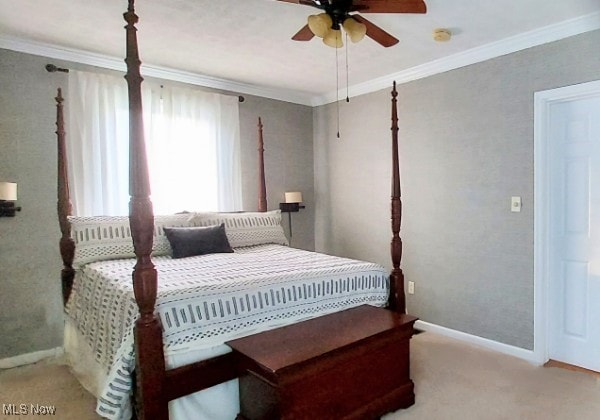 131 N Walnut St, Ravenna, OH 44266 - carpeted bedroom with ornamental molding, baseboards, and a ceiling fan