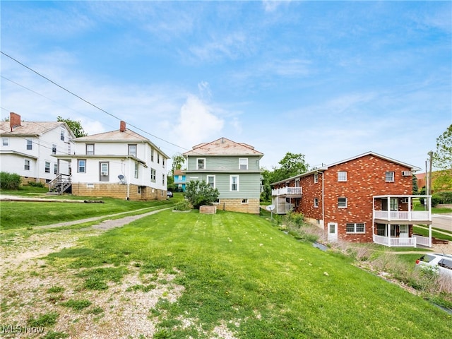 154 Montgomery Blvd, New Concord, OH 43762 - back of house with a lawn
