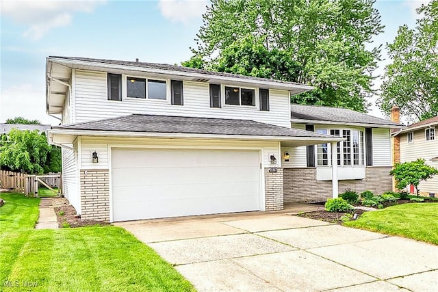 21517 Nottingham Dr, Fairview Park, OH 44126 - tri-level home with brick siding, concrete driveway, and an attached garage