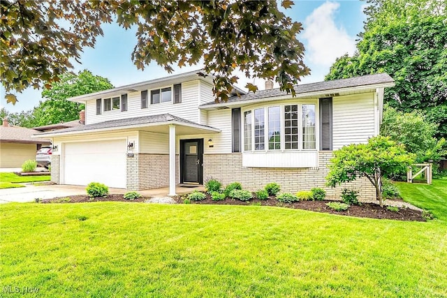 21517 Nottingham Dr, Fairview Park, OH 44126 - tri-level home featuring brick siding, a front yard, concrete driveway, and a garage