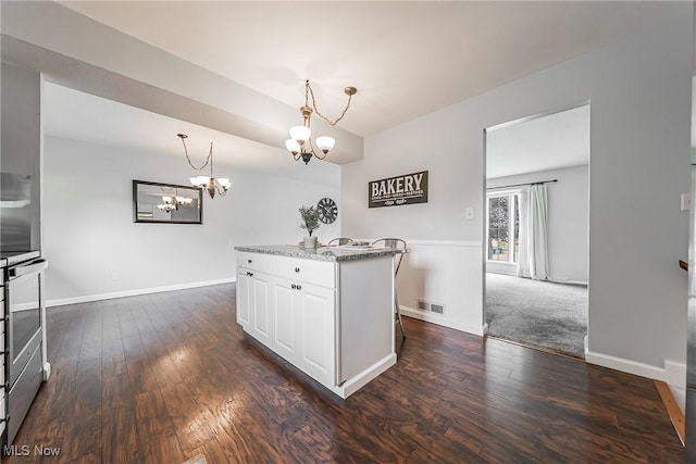 21517 Nottingham Dr, Fairview Park, OH 44126 - kitchen featuring a chandelier, white cabinetry, dark wood-type flooring, hanging light fixtures, and light stone countertops