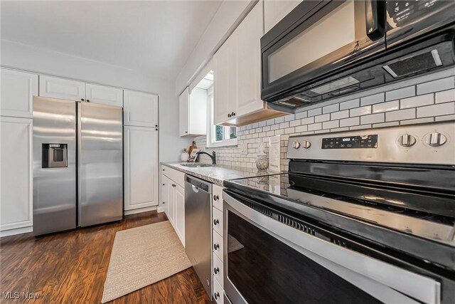 21517 Nottingham Dr, Fairview Park, OH 44126 - kitchen featuring appliances with stainless steel finishes, a sink, white cabinetry, and backsplash