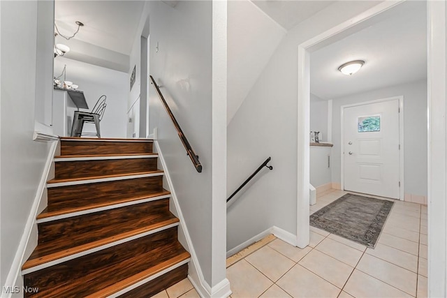 21517 Nottingham Dr, Fairview Park, OH 44126 - entrance foyer featuring light tile patterned flooring, baseboards, and stairway