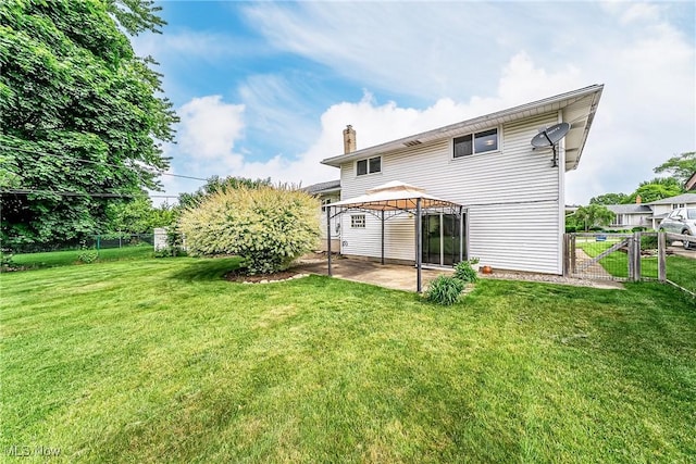 21517 Nottingham Dr, Fairview Park, OH 44126 - rear view of house featuring a gazebo, a patio area, a chimney, and a gate