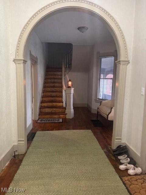 419 Commerce St, Wellsburg, WV 26070 - hall featuring arched walkways, dark wood finished floors, stairs, and baseboards