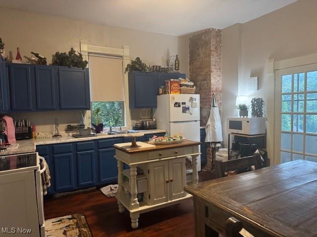 419 Commerce St, Wellsburg, WV 26070 - kitchen featuring blue cabinetry, white appliances, light countertops, dark wood-style floors, and a sink