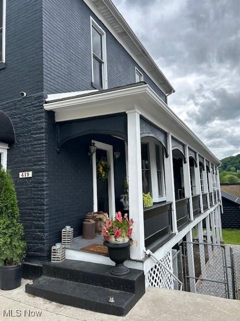 419 Commerce St, Wellsburg, WV 26070 - view of home's exterior featuring brick siding and a porch