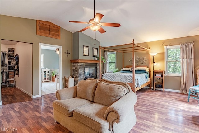 7170 Lafayette Rd, Medina, OH 44256 - bedroom with lofted ceiling, wood finished floors, baseboards, ceiling fan, and a fireplace