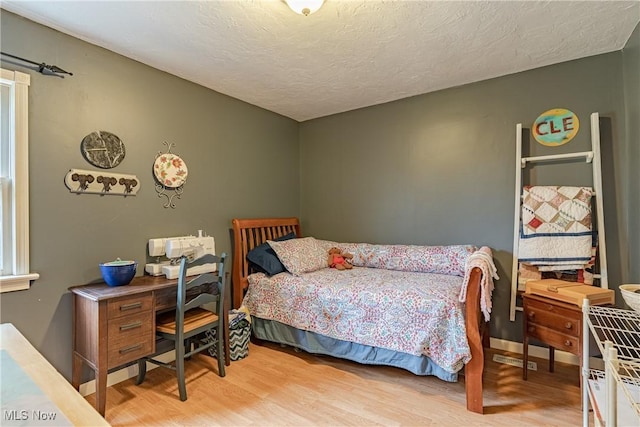 7170 Lafayette Rd, Medina, OH 44256 - bedroom featuring light wood-style floors and a textured ceiling