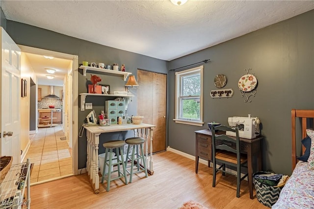 7170 Lafayette Rd, Medina, OH 44256 - home office with light wood-style flooring, baseboards, and a textured ceiling
