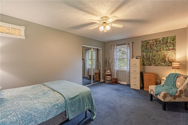 7170 Lafayette Rd, Medina, OH 44256 - bedroom featuring dark colored carpet, a textured ceiling, and ceiling fan