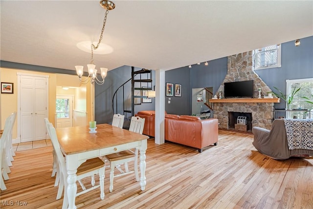 7170 Lafayette Rd, Medina, OH 44256 - dining space with stairs, light wood-style flooring, a chandelier, and plenty of natural light