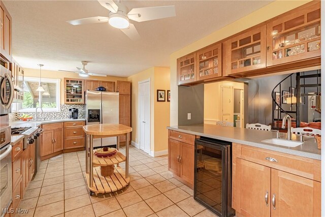 7170 Lafayette Rd, Medina, OH 44256 - kitchen featuring wine cooler, a sink, ceiling fan, light countertops, and light tile patterned flooring