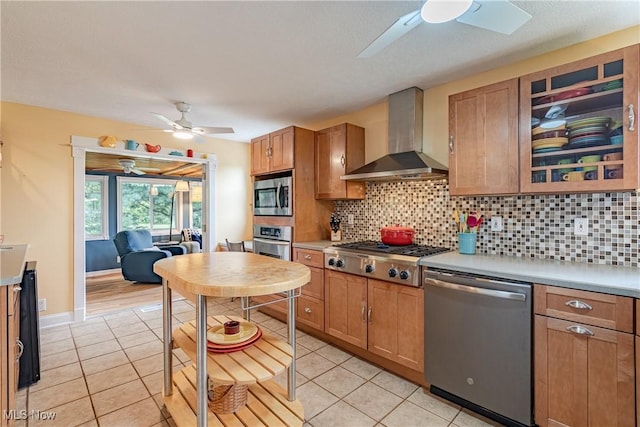 7170 Lafayette Rd, Medina, OH 44256 - kitchen with ceiling fan, stainless steel appliances, wall chimney range hood, and light tile patterned floors