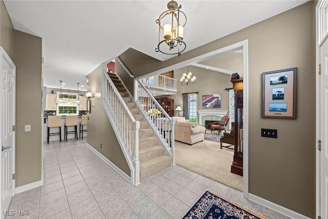 1955 Wendover Cir NE, North Canton, OH 44720 - entrance foyer with a chandelier, light colored carpet, stairway, light tile patterned floors, and a fireplace