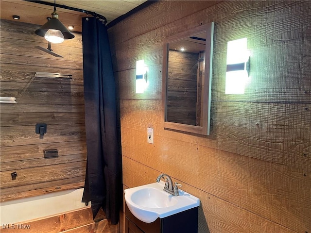 405 Bliss Ave, Conneaut, OH 44030 - bathroom with wood walls, vanity, and a shower with shower curtain