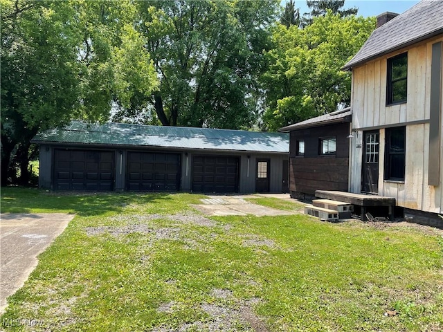 405 Bliss Ave, Conneaut, OH 44030 - view of green lawn featuring an outdoor structure and a garage