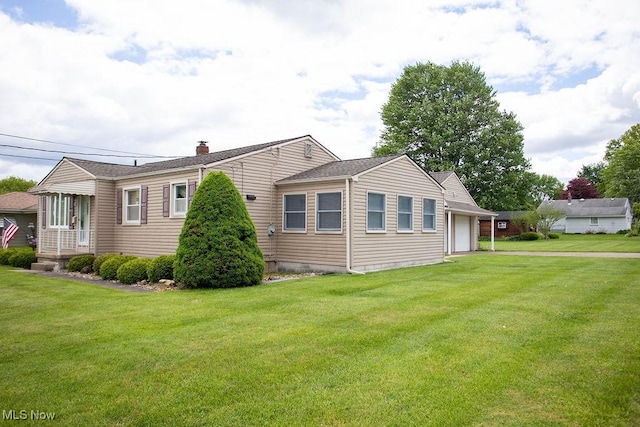 430 W Harvey St, Struthers, OH 44471 - view of property exterior featuring a yard, a chimney, and a garage
