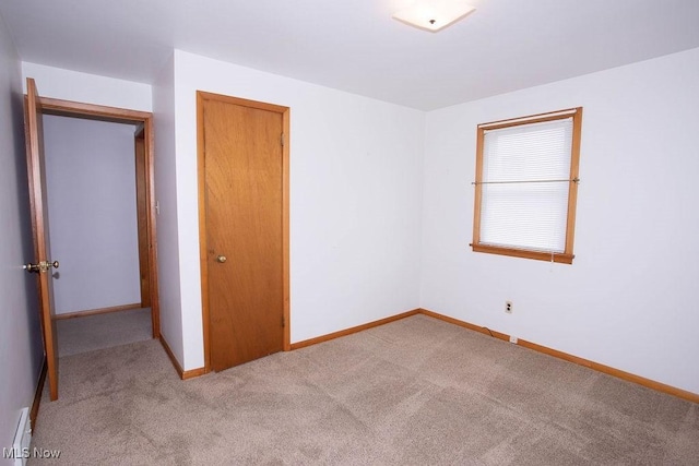 430 W Harvey St, Struthers, OH 44471 - unfurnished bedroom with light carpet, baseboards, and a closet
