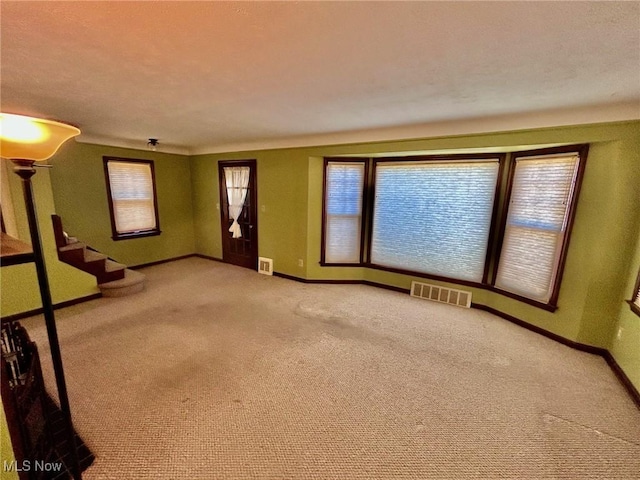 104 Sunnycliff Dr, Euclid, OH 44123 - unfurnished living room with baseboards, carpet floors, and healthy amount of natural light