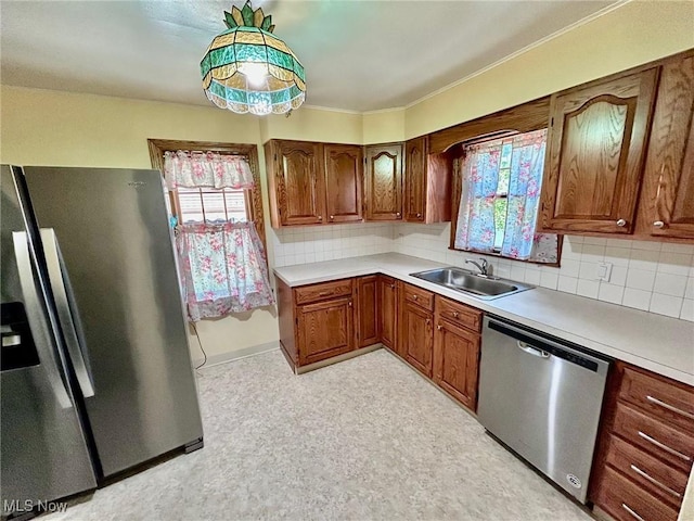 104 Sunnycliff Dr, Euclid, OH 44123 - kitchen with stainless steel appliances, a sink, plenty of natural light, light countertops, and ornamental molding