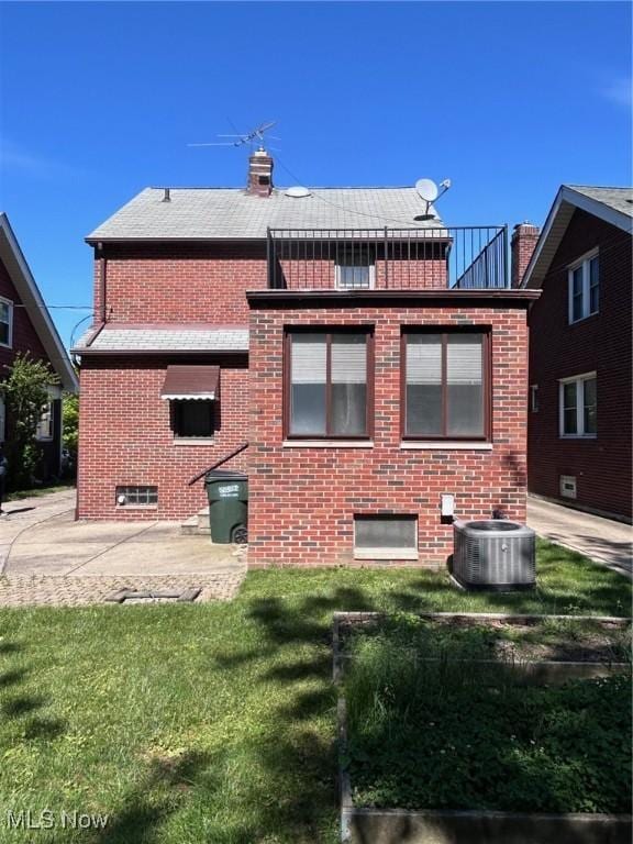 104 Sunnycliff Dr, Euclid, OH 44123 - back of house with central AC, brick siding, a chimney, and a yard